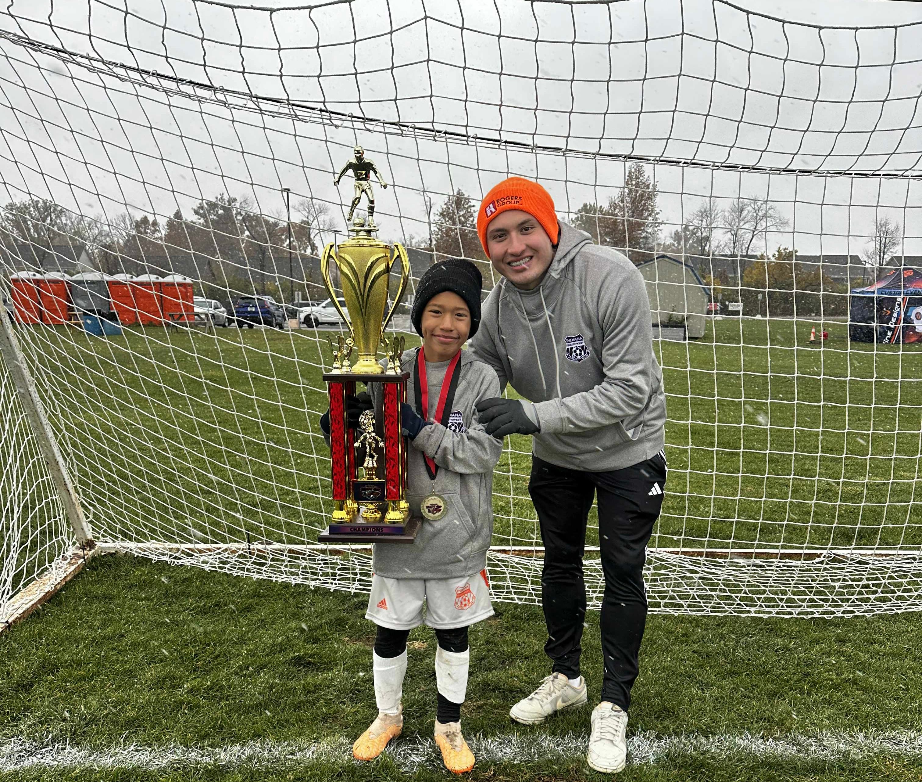 Soccer coach working with young athlete