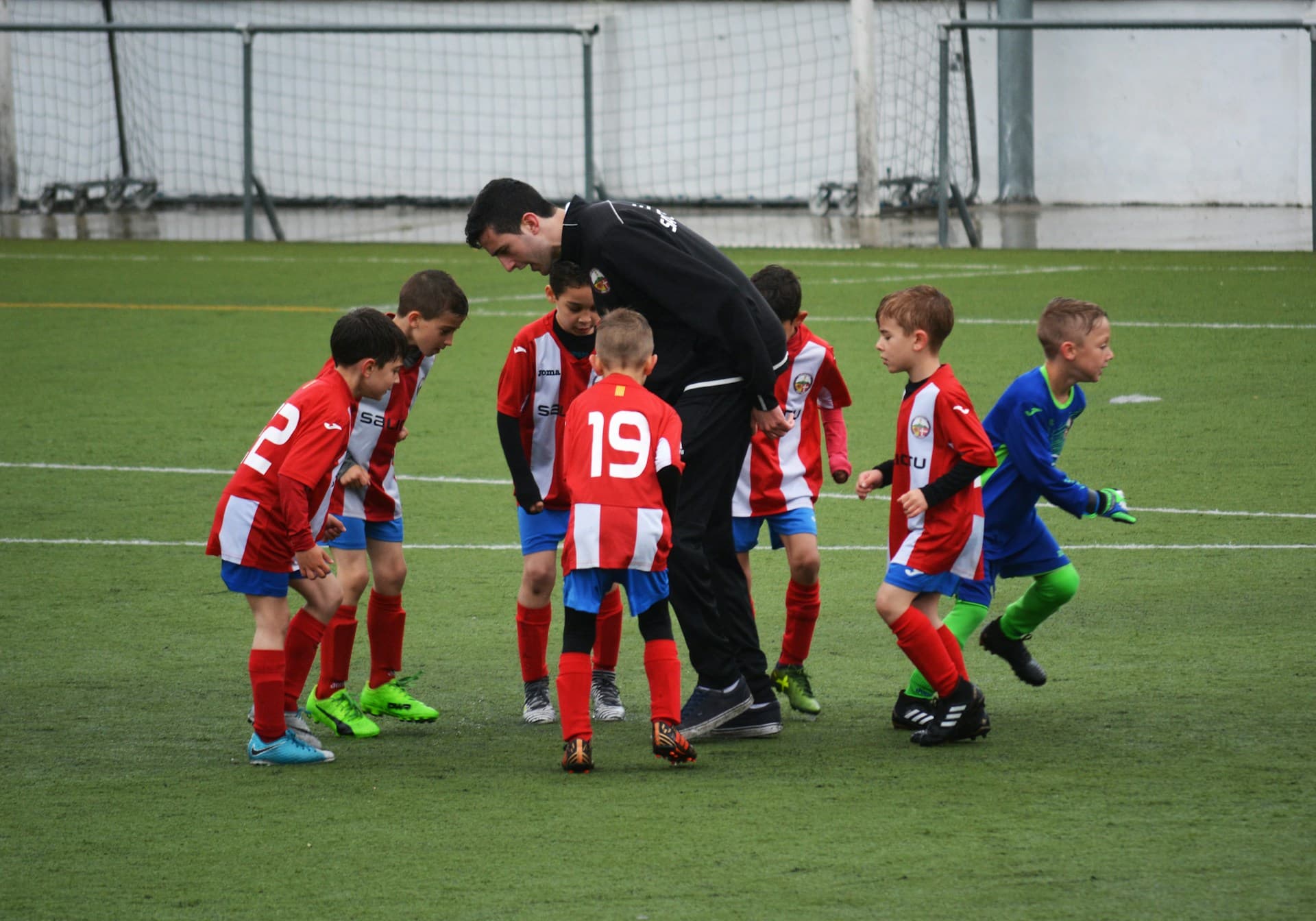 Soccer coach working with young athlete